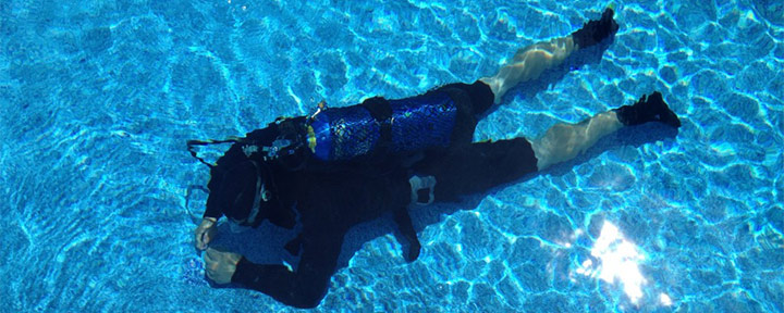 scuba diver repairing the leak in the pool
