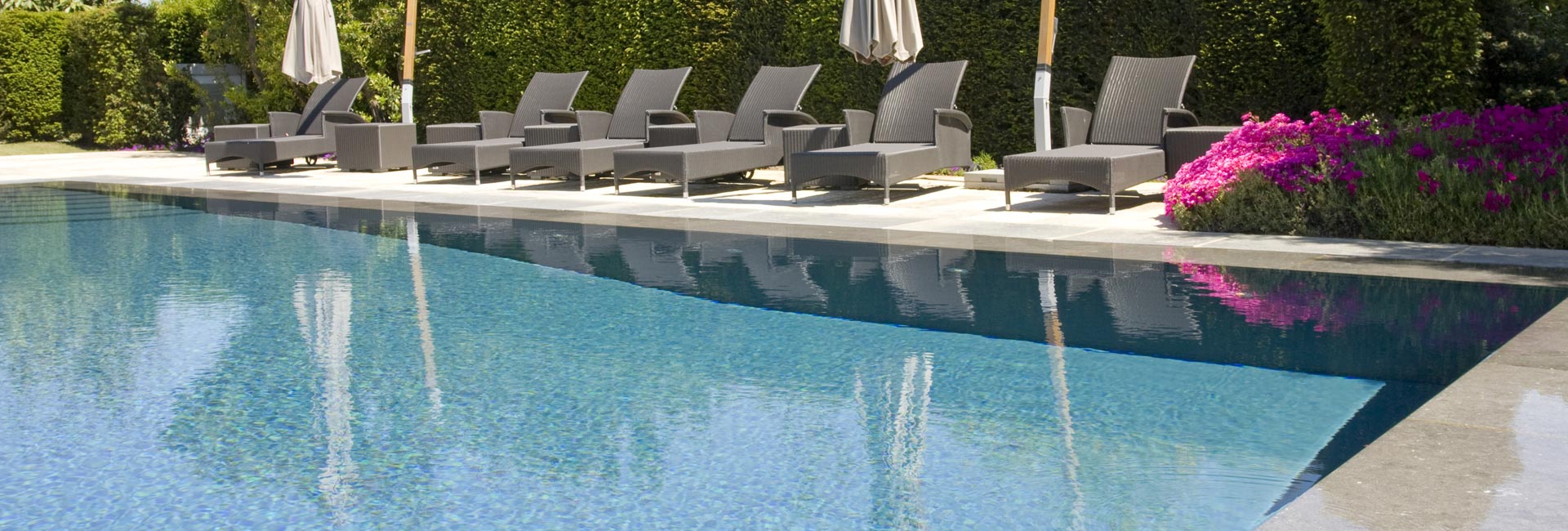 side view of swimming pool with lounge chairs