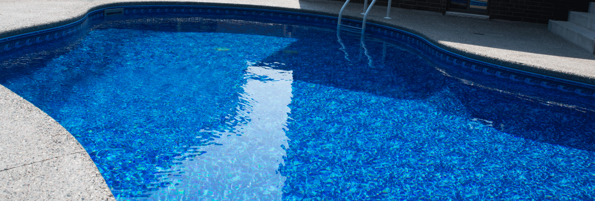 large rectangular swimming pool in backyard with beautiful background